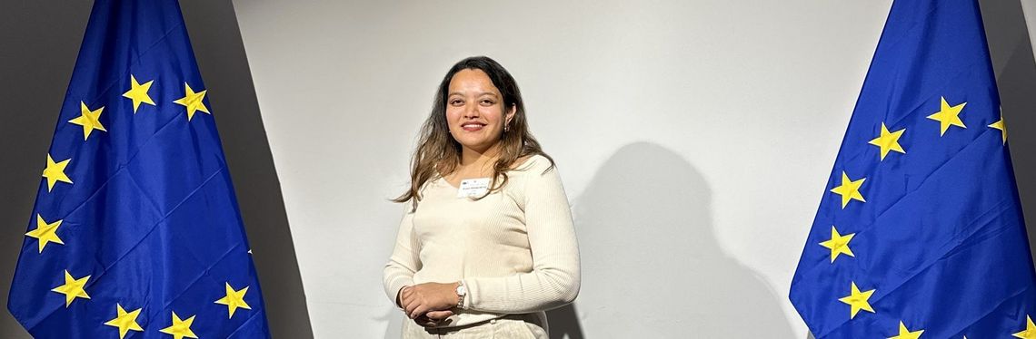 Woman standing between two EU flags