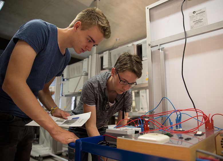 Bild I: Conrad Sonntag (links) und Justin-Leon Tropschug lesen Daten von den Messgeräten der mobilen Photovoltaikanlage ab. Bild II: Die Teilnehmerinnen und Teilnehmer der Sommerschule der Hochschule Harz erlebten vier Tage mit Experimenten und einem Ein